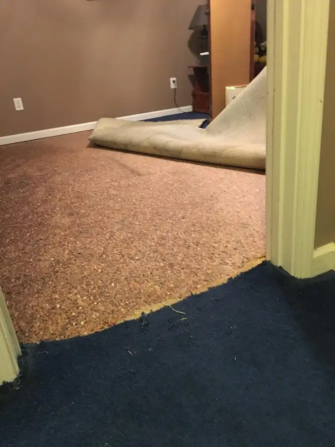 Carpet pad removal revealing water damage during Water Mitigation Services in Tahlequah